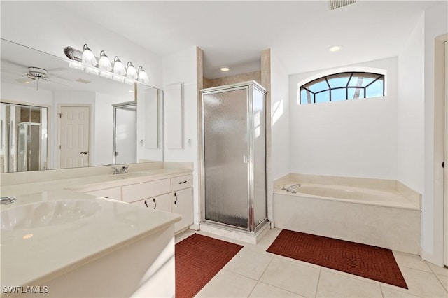 bathroom featuring tile patterned floors, a stall shower, and a sink