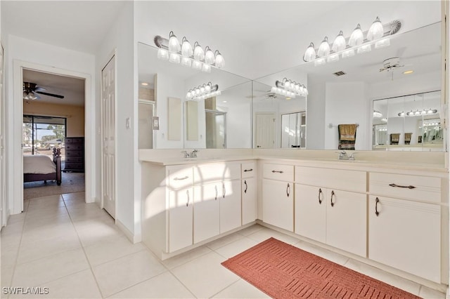 bathroom featuring vanity, ensuite bath, a ceiling fan, and tile patterned flooring