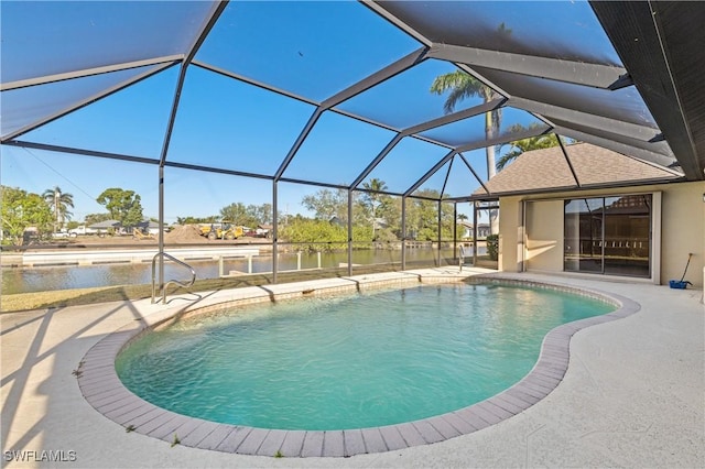 outdoor pool featuring a lanai, a patio area, and a water view