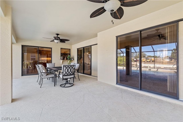 view of patio featuring outdoor dining area and a ceiling fan