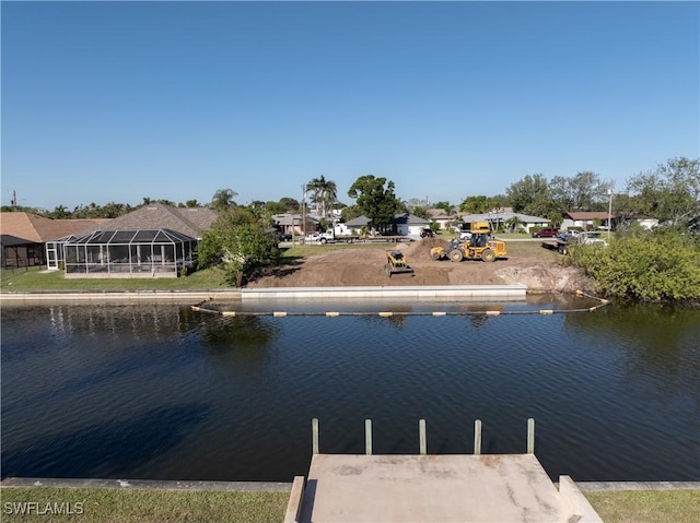 view of dock with a residential view and a water view