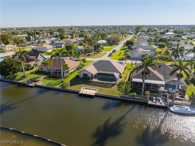 drone / aerial view with a residential view and a water view