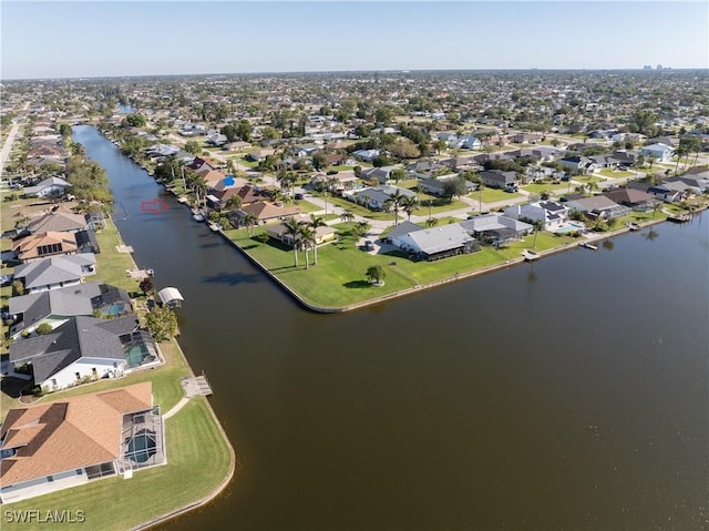 drone / aerial view featuring a residential view and a water view