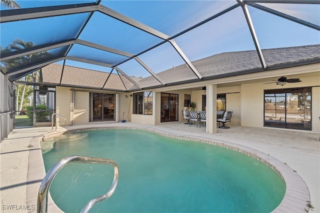 pool featuring a lanai, a patio area, and ceiling fan