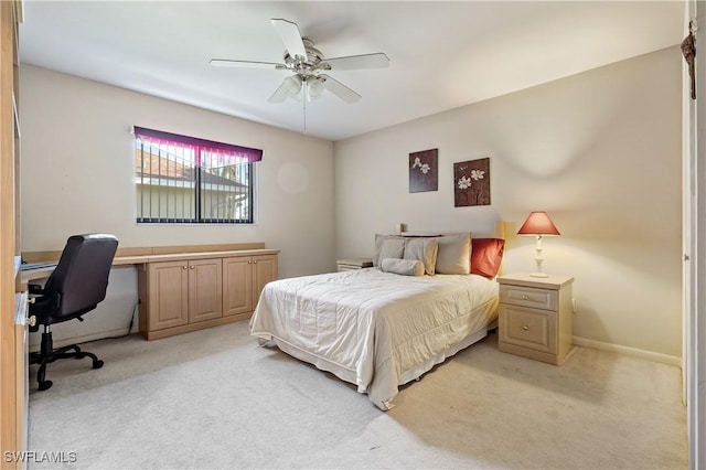 bedroom featuring light colored carpet, baseboards, and ceiling fan