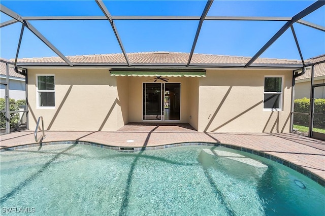 pool featuring glass enclosure and a patio