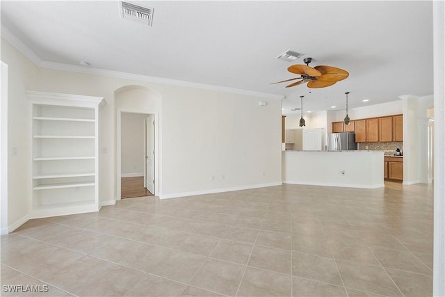 unfurnished living room with visible vents, arched walkways, ornamental molding, and a ceiling fan