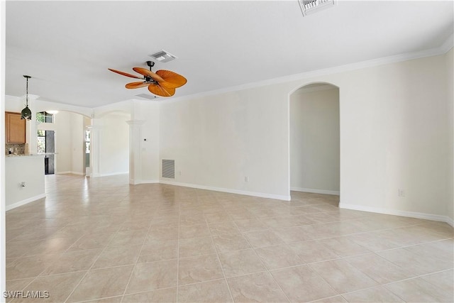 unfurnished room with visible vents, arched walkways, and a ceiling fan