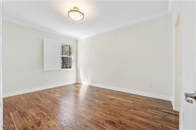 empty room with baseboards, wood finished floors, and ornamental molding