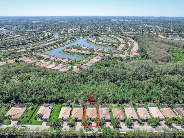 drone / aerial view featuring a residential view and a water view