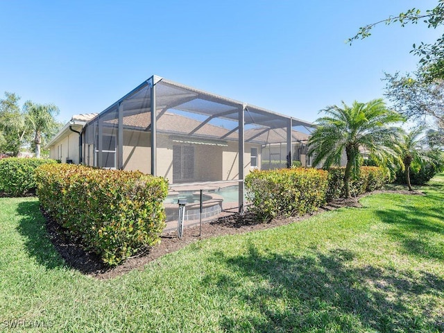 view of yard with an outdoor pool and glass enclosure