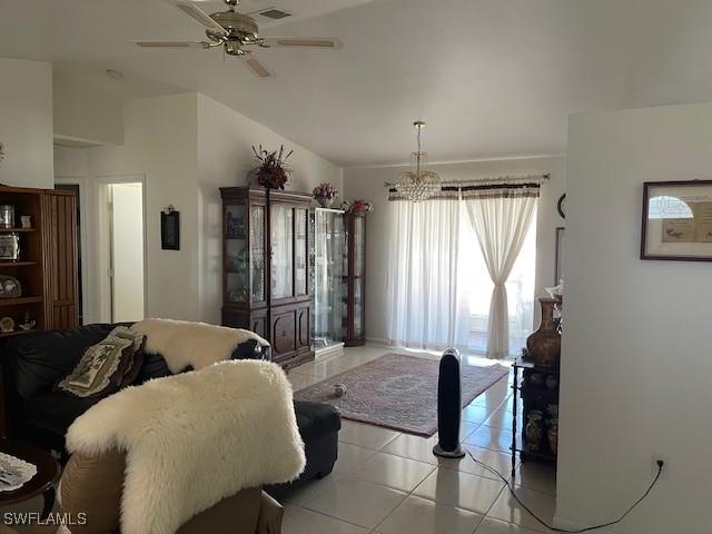 bedroom featuring light tile patterned floors, visible vents, and ceiling fan with notable chandelier