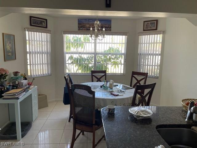 dining room with a wealth of natural light, a chandelier, and light tile patterned floors