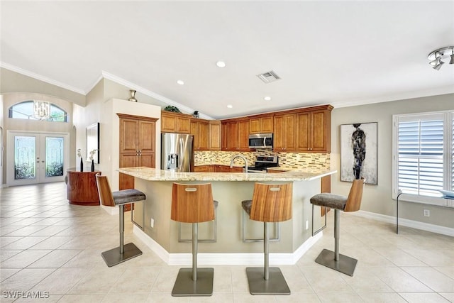 kitchen featuring light tile patterned floors, visible vents, french doors, and stainless steel appliances