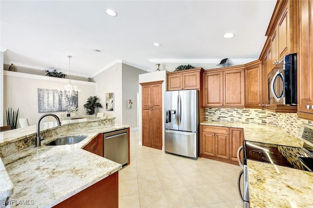 kitchen featuring ornamental molding, a sink, tasteful backsplash, stainless steel appliances, and light stone countertops