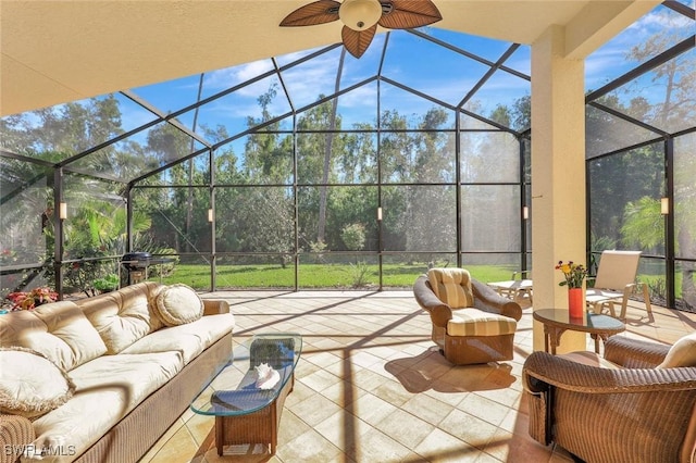 view of patio / terrace with an outdoor living space, glass enclosure, and a ceiling fan