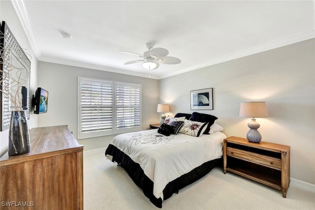 bedroom featuring crown molding, a ceiling fan, baseboards, and carpet floors