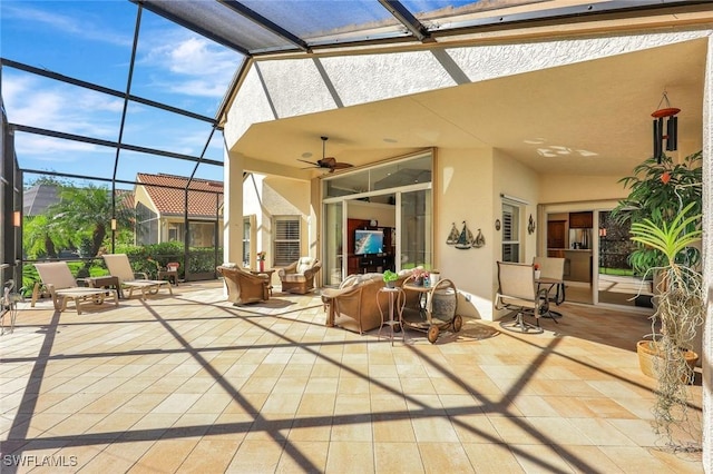 view of patio / terrace featuring glass enclosure, ceiling fan, and outdoor lounge area