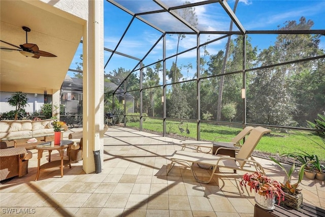 view of patio featuring glass enclosure and a ceiling fan