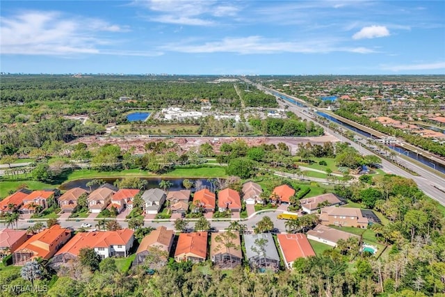 drone / aerial view with a residential view and a water view