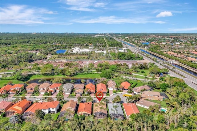 drone / aerial view featuring a residential view and a water view