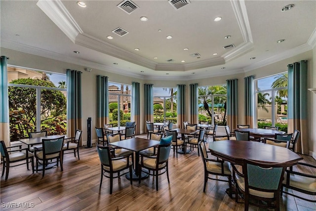 dining room featuring visible vents and a raised ceiling