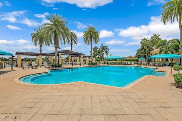 community pool with a patio and a pergola