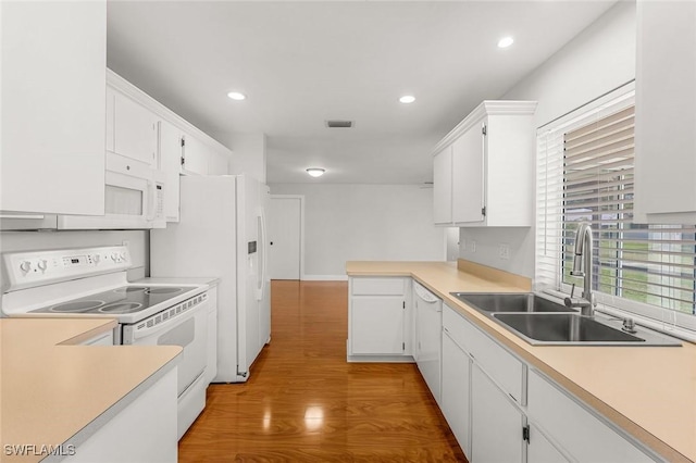 kitchen featuring light wood-style flooring, a sink, white cabinetry, white electric stove, and light countertops