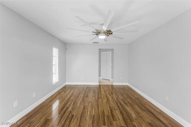 unfurnished room with a ceiling fan, baseboards, and wood finished floors