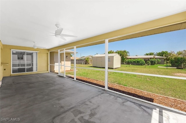 unfurnished sunroom featuring ceiling fan