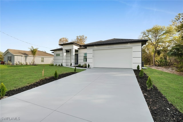 prairie-style house with a front yard, an attached garage, driveway, and stucco siding