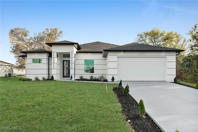 prairie-style home with stucco siding, driveway, a front lawn, and an attached garage