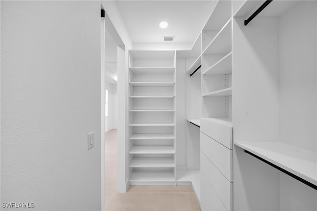 walk in closet with light tile patterned flooring and visible vents