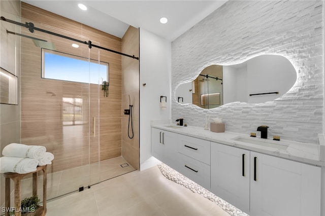 full bathroom with double vanity, decorative backsplash, a shower stall, and a sink