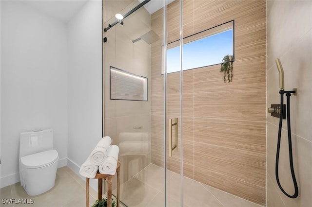 bathroom featuring baseboards, toilet, a stall shower, and tile patterned flooring