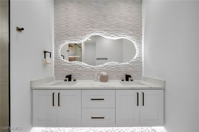 full bath featuring double vanity, backsplash, and a sink