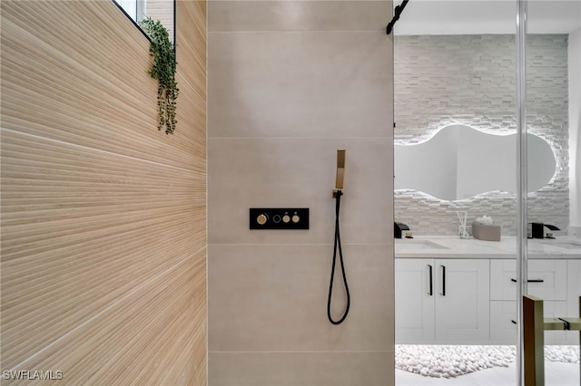 full bathroom featuring vanity, tile walls, and a shower