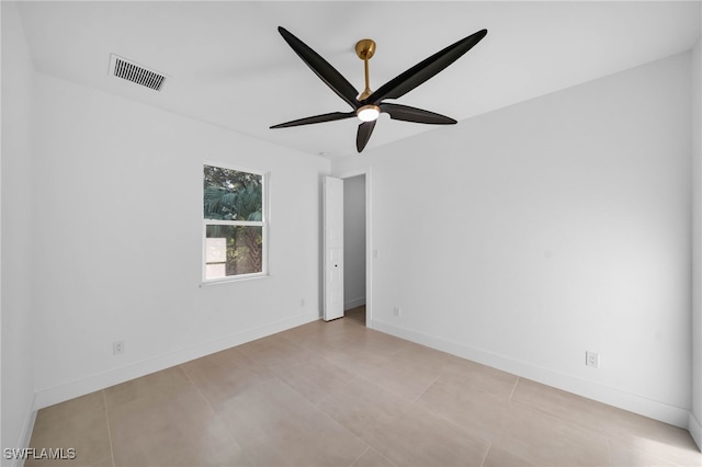 unfurnished room with visible vents, ceiling fan, and baseboards