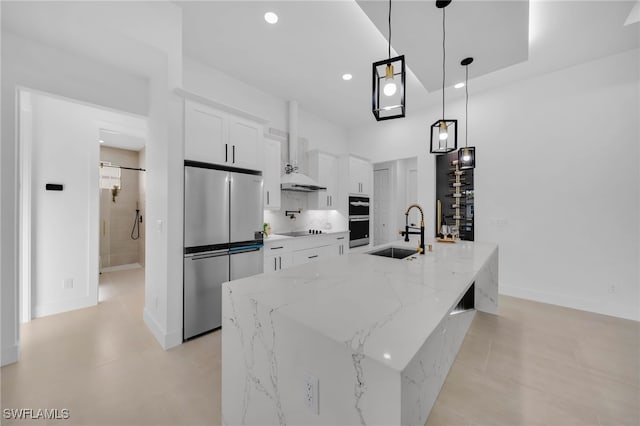 kitchen featuring a large island, a sink, white cabinetry, recessed lighting, and appliances with stainless steel finishes