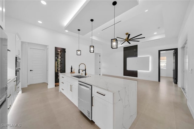 kitchen with white cabinetry, a raised ceiling, appliances with stainless steel finishes, and a sink