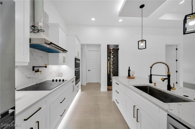 kitchen featuring decorative backsplash, a sink, wall chimney range hood, black electric cooktop, and dishwasher