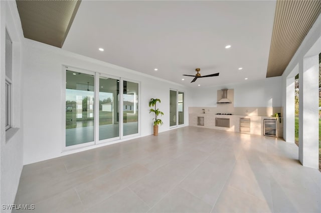 unfurnished living room with wine cooler, recessed lighting, tile patterned floors, and a ceiling fan