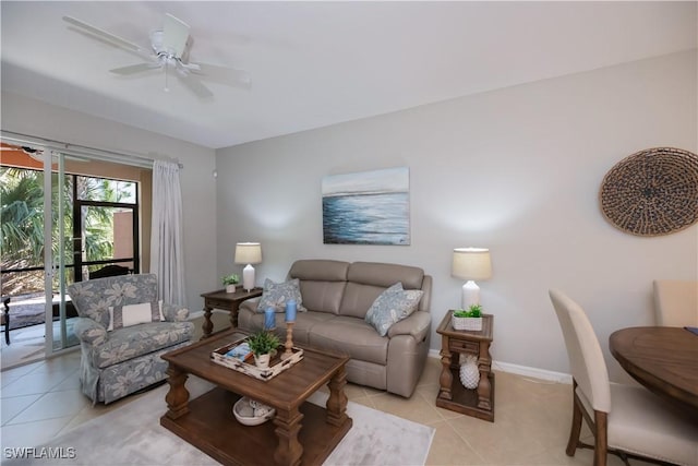living room featuring baseboards, light tile patterned flooring, and a ceiling fan
