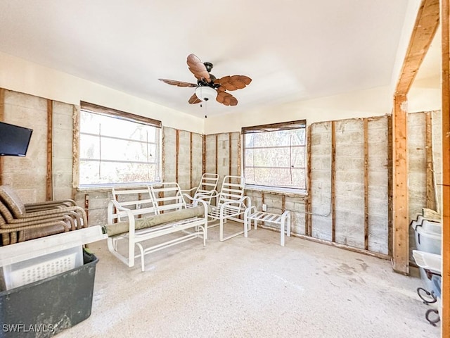 sunroom / solarium with a ceiling fan