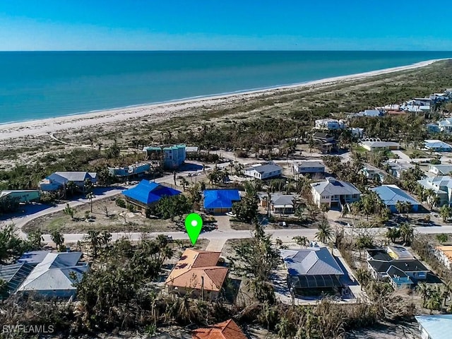 drone / aerial view featuring a water view and a beach view