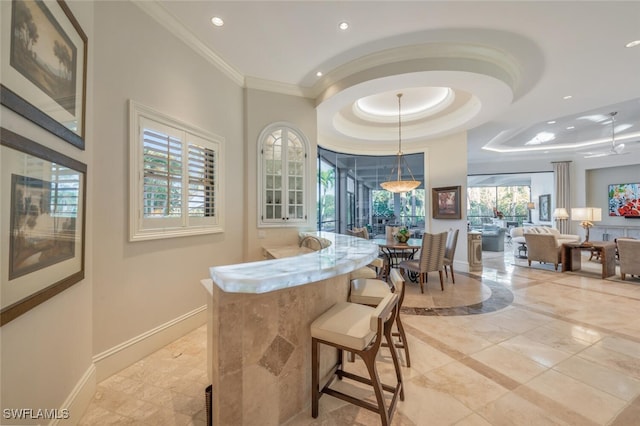 29115 W Teramo Way, Naples, FL 34110 - interior space featuring recessed lighting, a tray ceiling, baseboards, ornamental molding, and hanging light fixtures