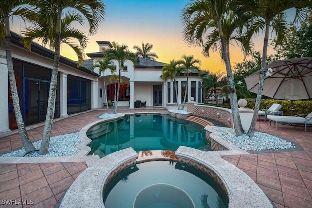 29115 W Teramo Way, Naples, FL 34110 - pool at dusk with a patio area and a pool with connected hot tub