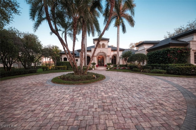 29115 W Teramo Way, Naples, FL 34110 - mediterranean / spanish house featuring stucco siding and curved driveway