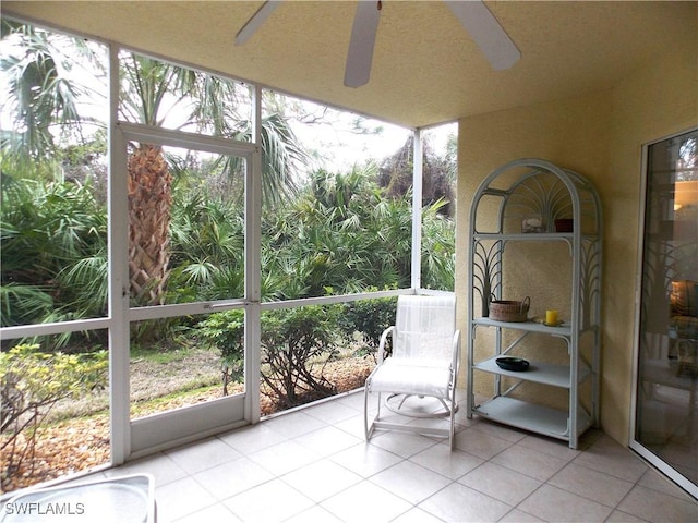 unfurnished sunroom with ceiling fan