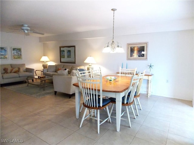 dining room featuring light tile patterned floors and ceiling fan with notable chandelier